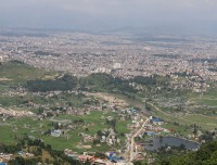 Man sitting on hill, overlooking Kathmandu Valley from Chamapdevi view point